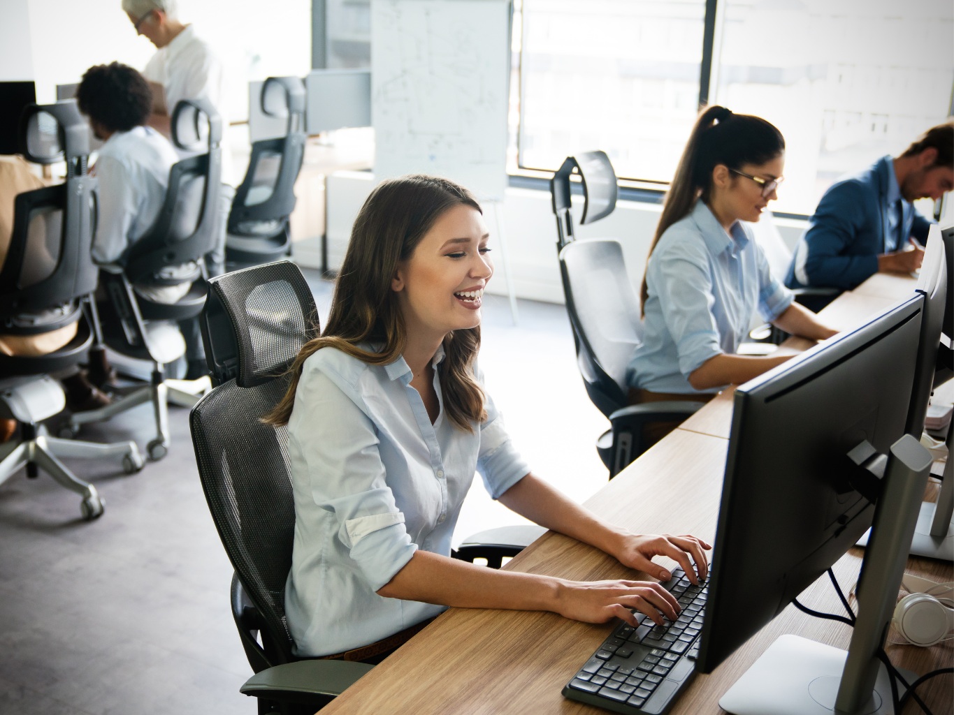 A professional office setting with employees collaborating on document management and payment processing tasks, showcasing efficiency and teamwork.