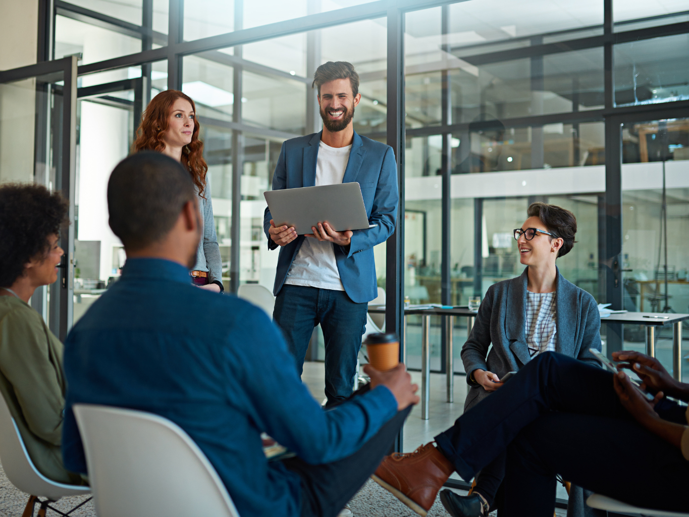 a group of staff gathered at a meeting collaborating on how to best meet customer requirements